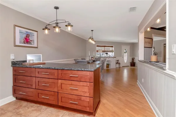 a living room with granite countertop furniture and a kitchen view