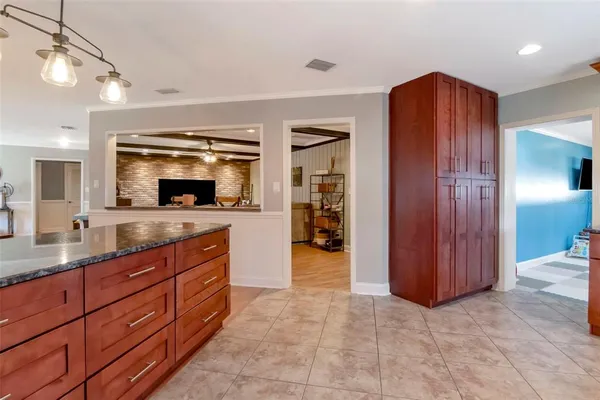 a spacious bathroom with a granite countertop sink and a mirror