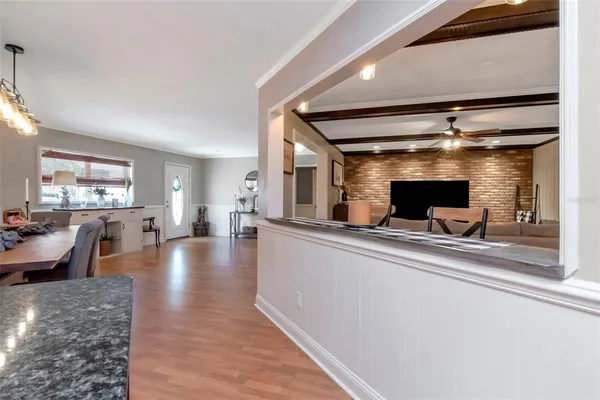 a view of a living room and kitchen with furniture