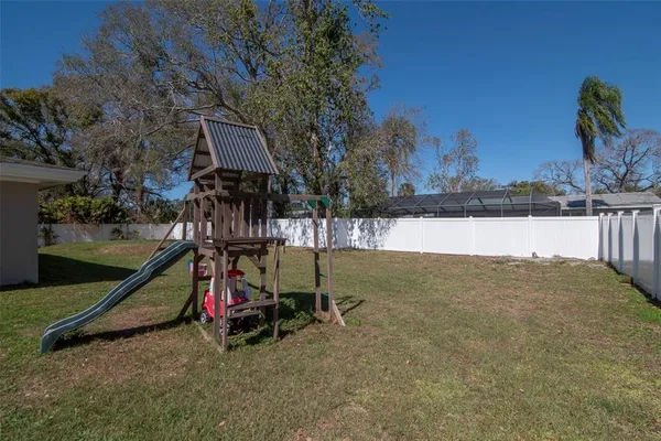 an aerial view of a house with swimming pool and lake view