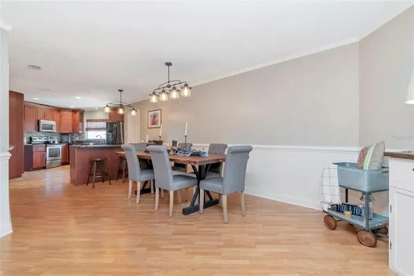 a view of a dining room with furniture and wooden floor