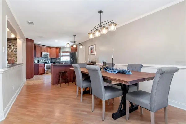 a view of a dining room with furniture and chandelier