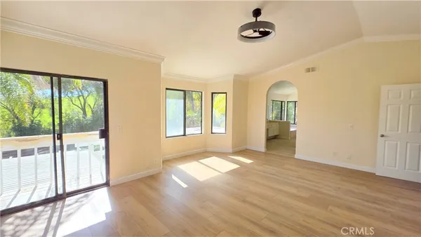a view of an empty room with glass door