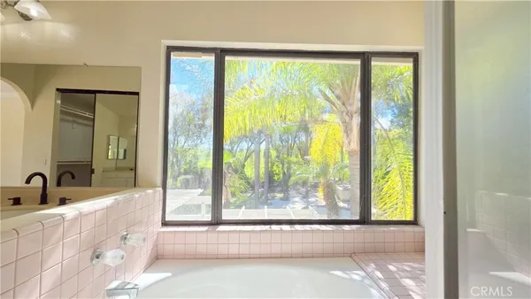 a bathroom with a large tub and shower