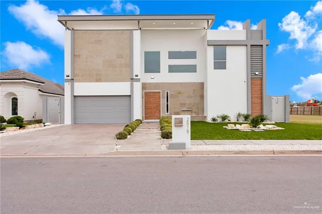 a view of a house with a garden and pathway