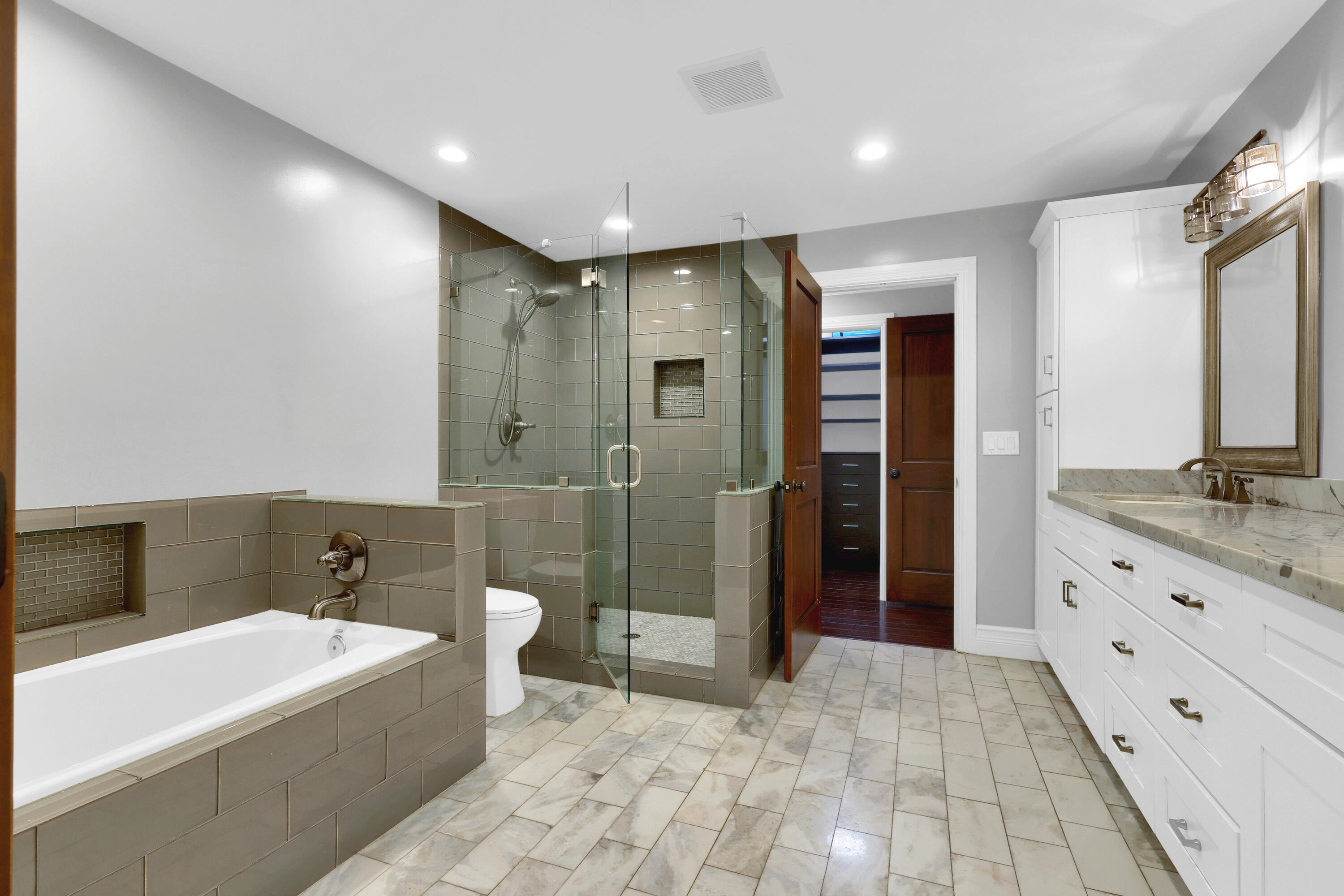 14701 Southwest 63rd Street Southwest Ranches, FL 33330 - Photo 29 of 47 a spacious bathroom with a tub shower a sink and mirror