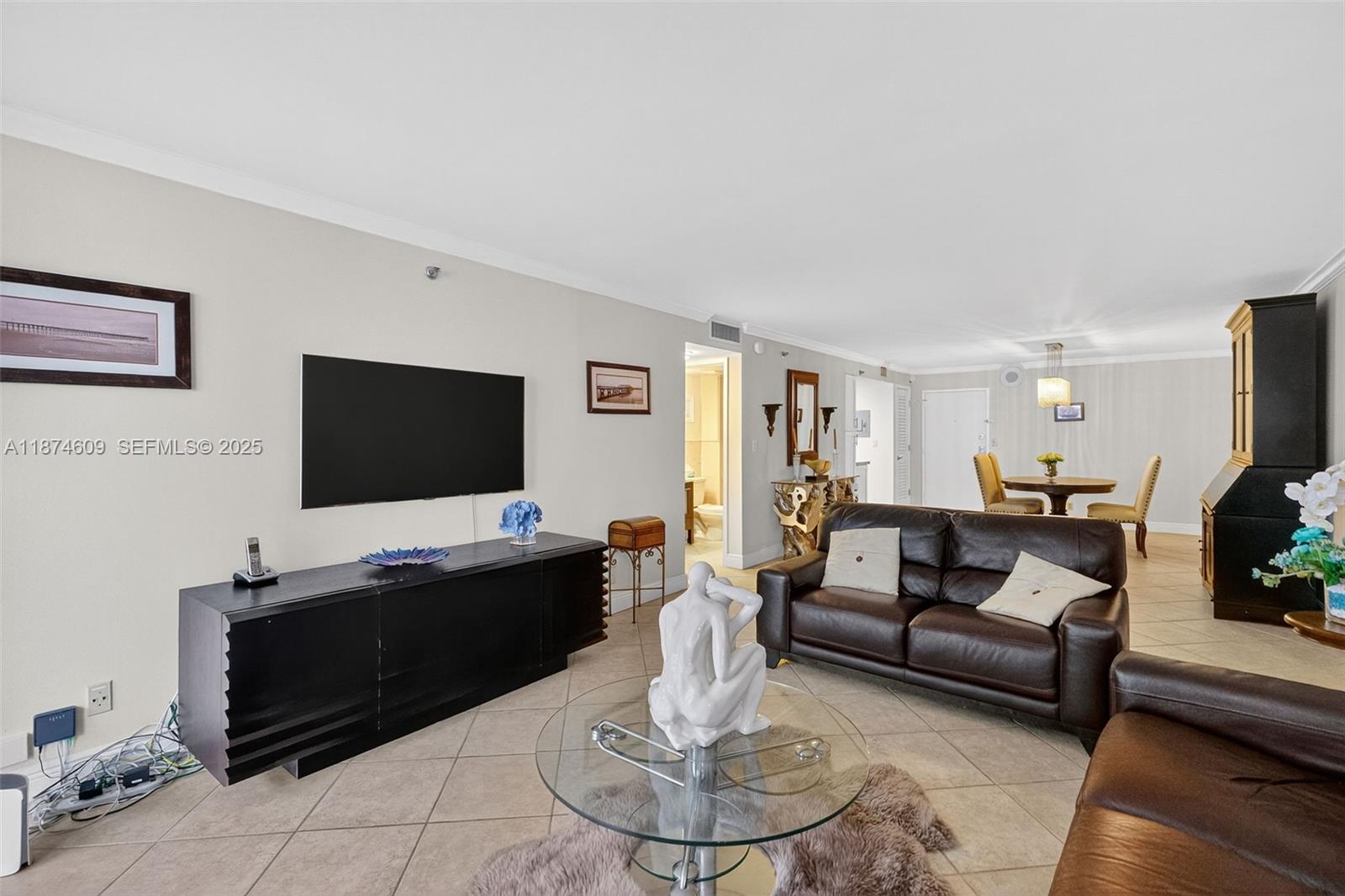 2401 Collins Avenue, Unit 1005 Miami Beach, FL 33140 - Photo 8 of 19 a living room with furniture and a flat screen tv