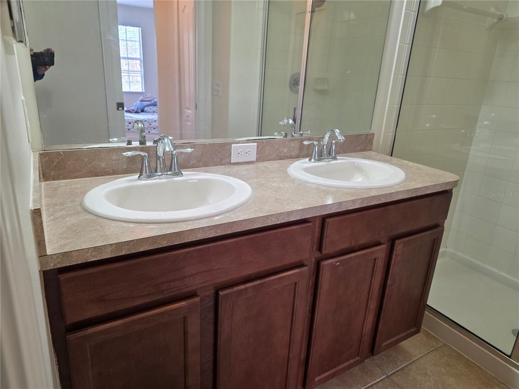 3158 Rodrick Circle Orlando, FL 32824 - Photo 16 of 17 a bathroom with a sink and a mirror