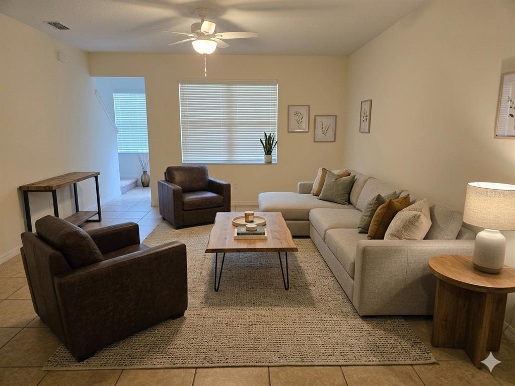 3158 Rodrick Circle Orlando, FL 32824 - Photo 3 of 17 a living room with furniture a lamp and a window