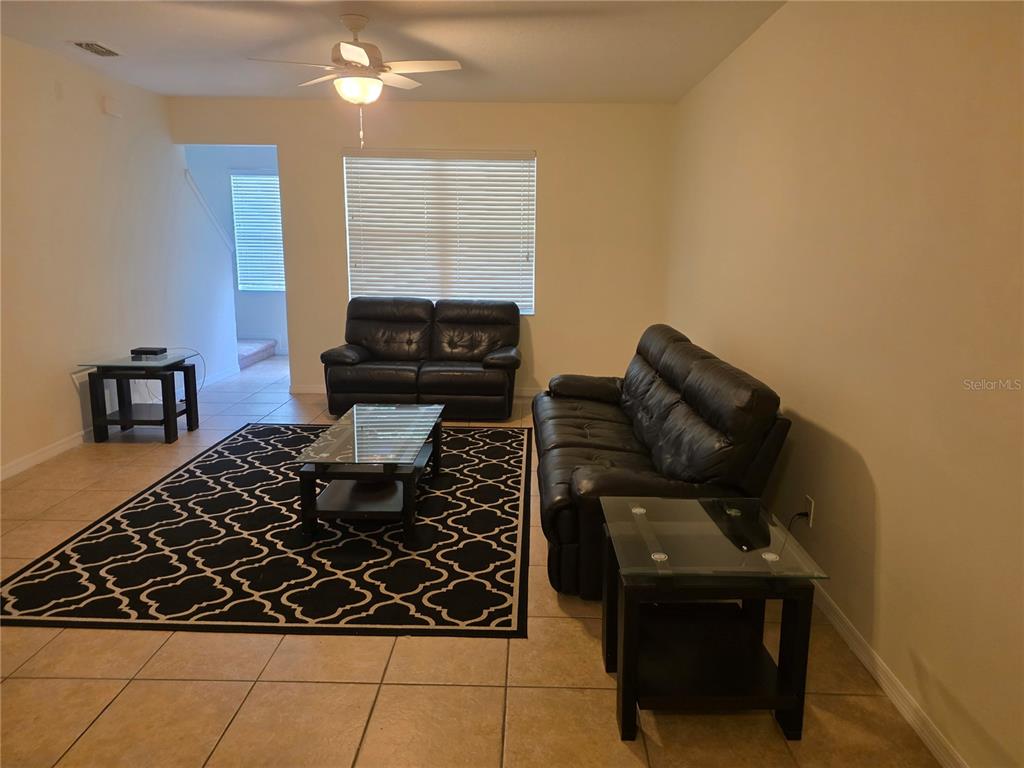 3158 Rodrick Circle Orlando, FL 32824 - Photo 4 of 17 a living room with a couch and a stove top oven