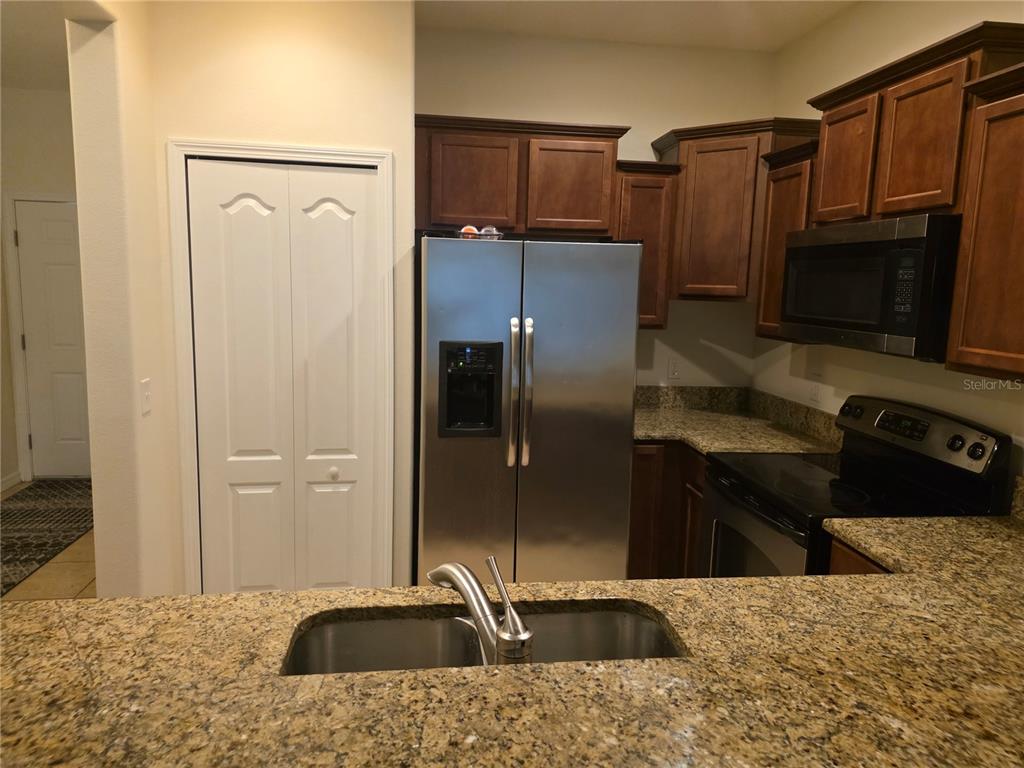 3158 Rodrick Circle Orlando, FL 32824 - Photo 5 of 17 a kitchen with a refrigerator sink and microwave