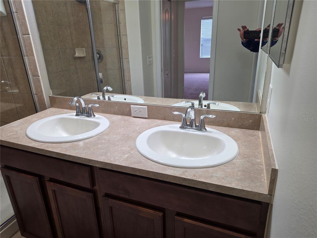3158 Rodrick Circle Orlando, FL 32824 - Photo 9 of 17 a bathroom with a sink and a mirror
