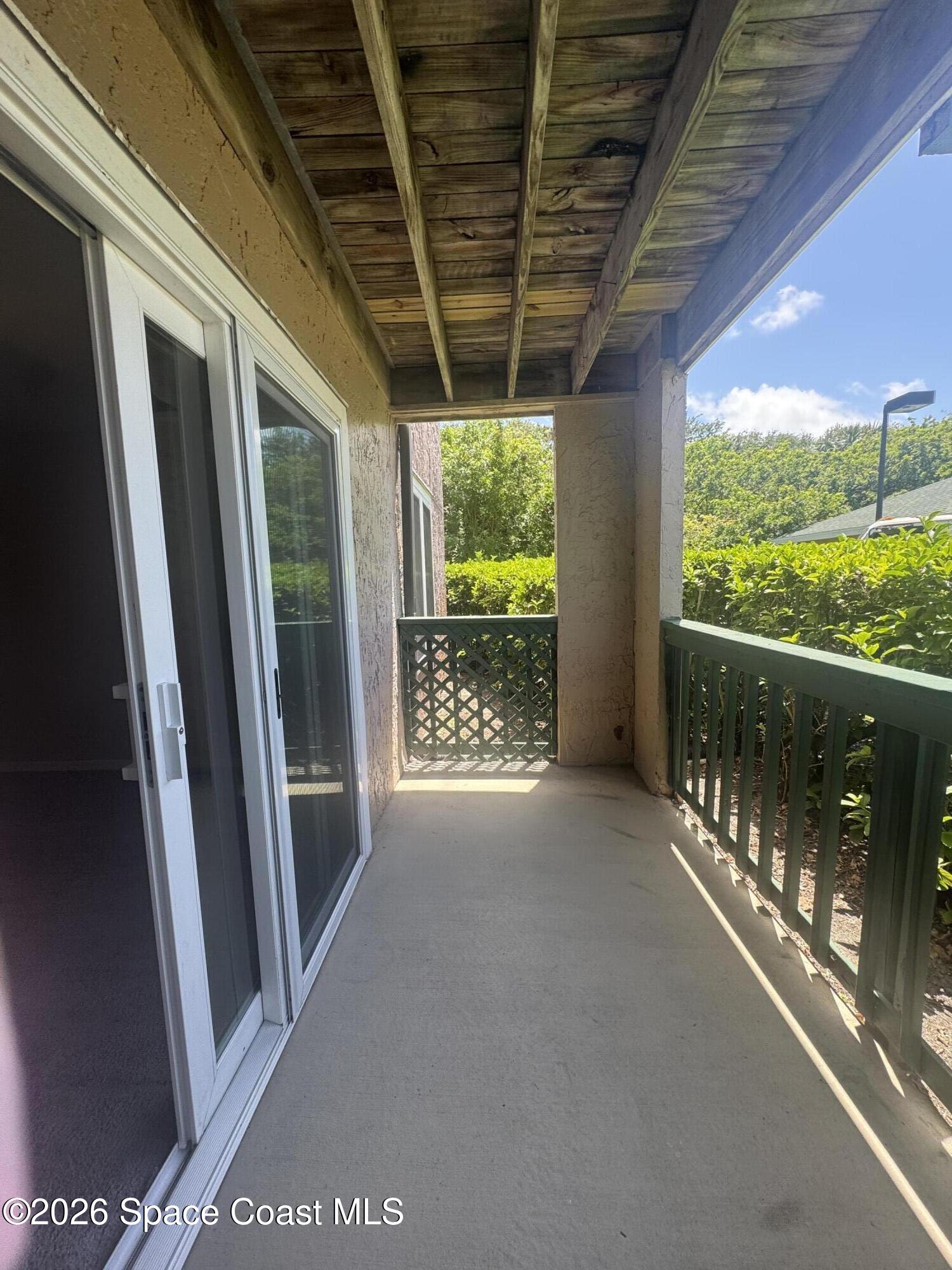7667 North Wickham Road, Unit 1107 Melbourne, FL 32940 - Photo 15 of 19 a view of a porch with furniture and floor to ceiling window