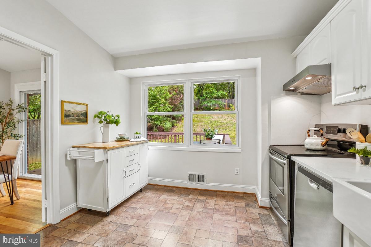 827 Caddington Avenue Silver Spring, MD 20901 - Photo 15 of 45 a kitchen with a stove a sink and a refrigerator