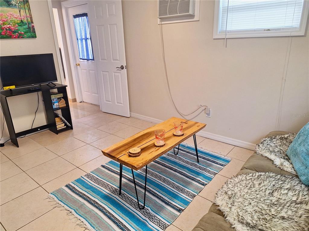 113 174th Avenue East Redington Shores, FL 33708 - Photo 4 of 16 a living room with a bed furniture and a window