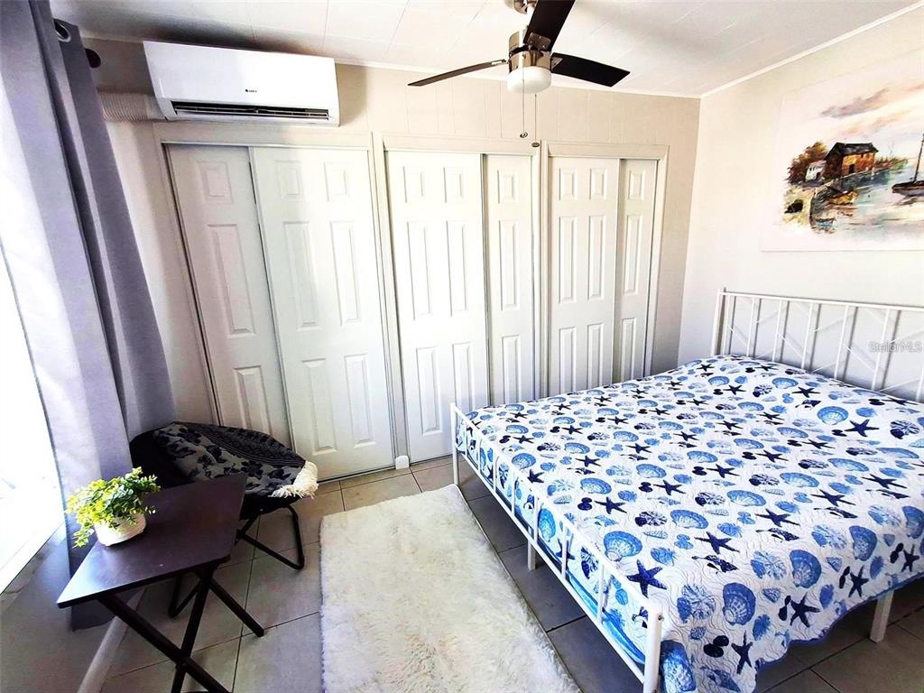 113 174th Avenue East Redington Shores, FL 33708 - Photo 6 of 16 a bed sitting in a bedroom next to a window