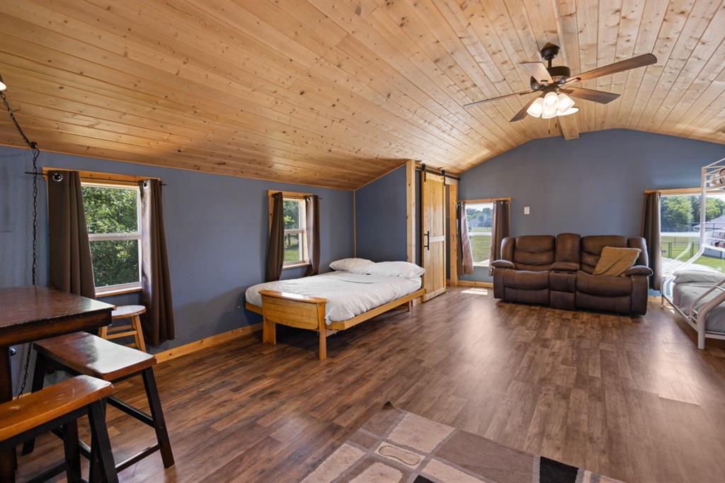 227 Scenic Road Trinidad, TX 75163 - Photo 35 of 40 a living room with furniture a ceiling fan and a wooden floor