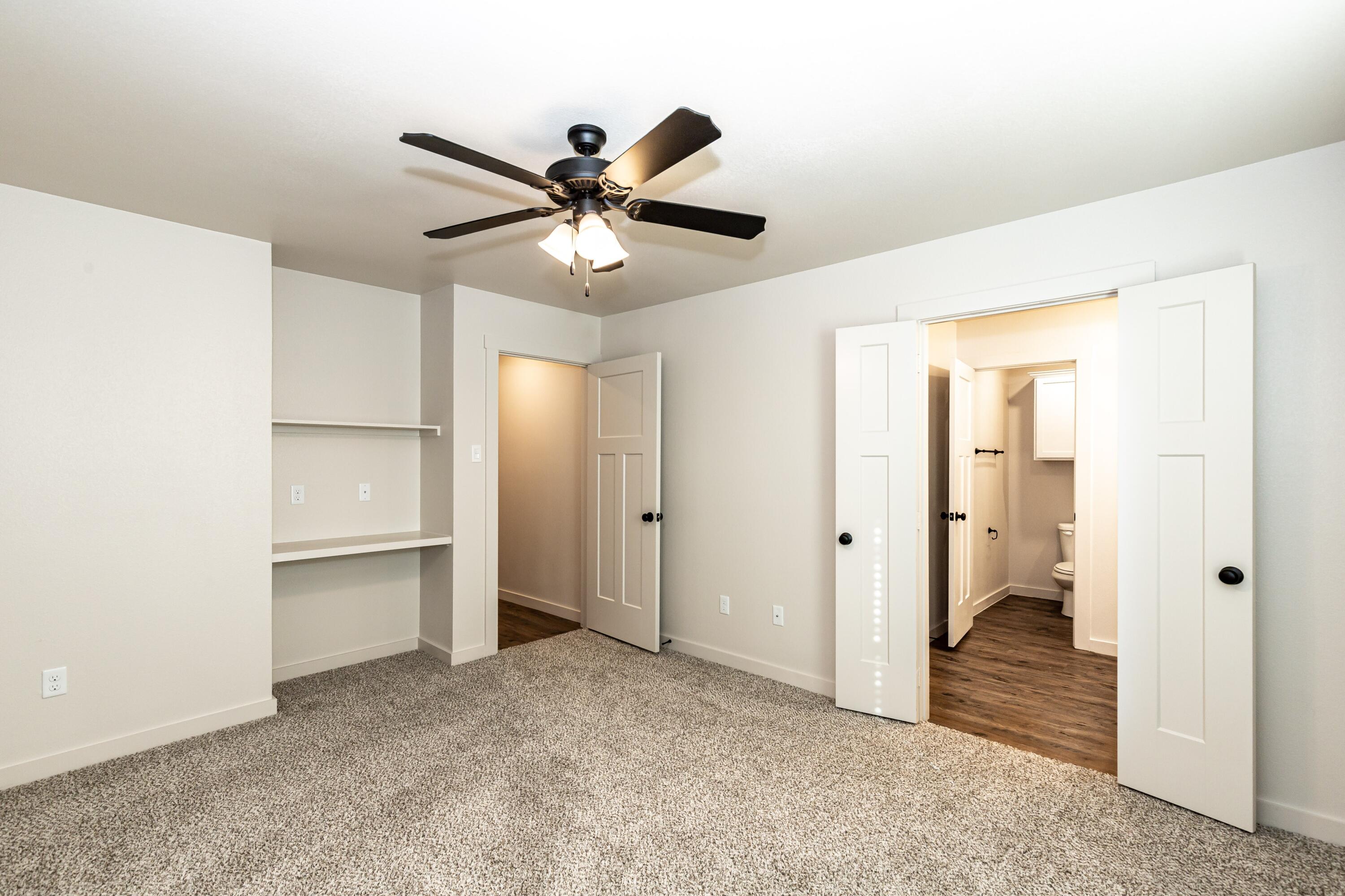 2529 138th Street Lubbock, TX 79423 - Photo 19 of 24 a view of a livingroom with a chandelier fan and closet