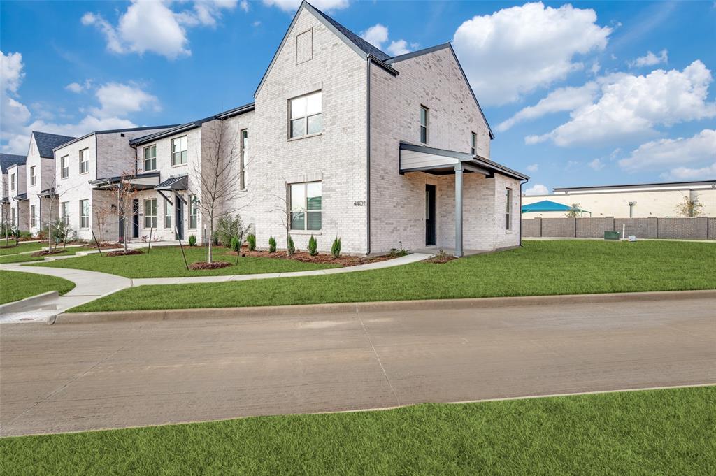 a view of a house with a big yard and large trees