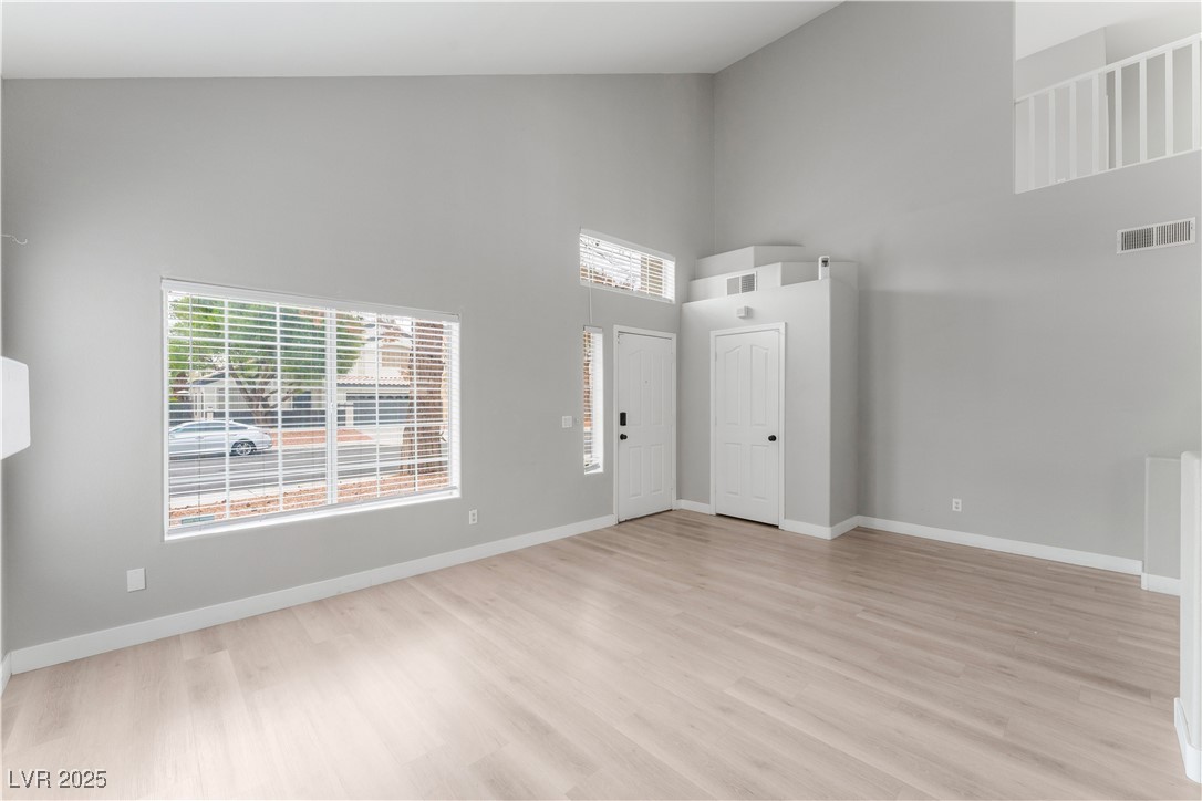 3695 Funston Way Las Vegas, NV 89129 - Photo 14 of 43 Entrance foyer featuring high vaulted ceiling, healthy amount of natural light, and light wood finished floors