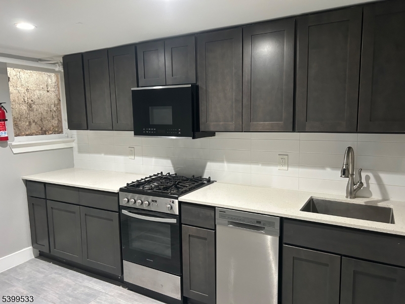 a kitchen with a sink stove and microwave