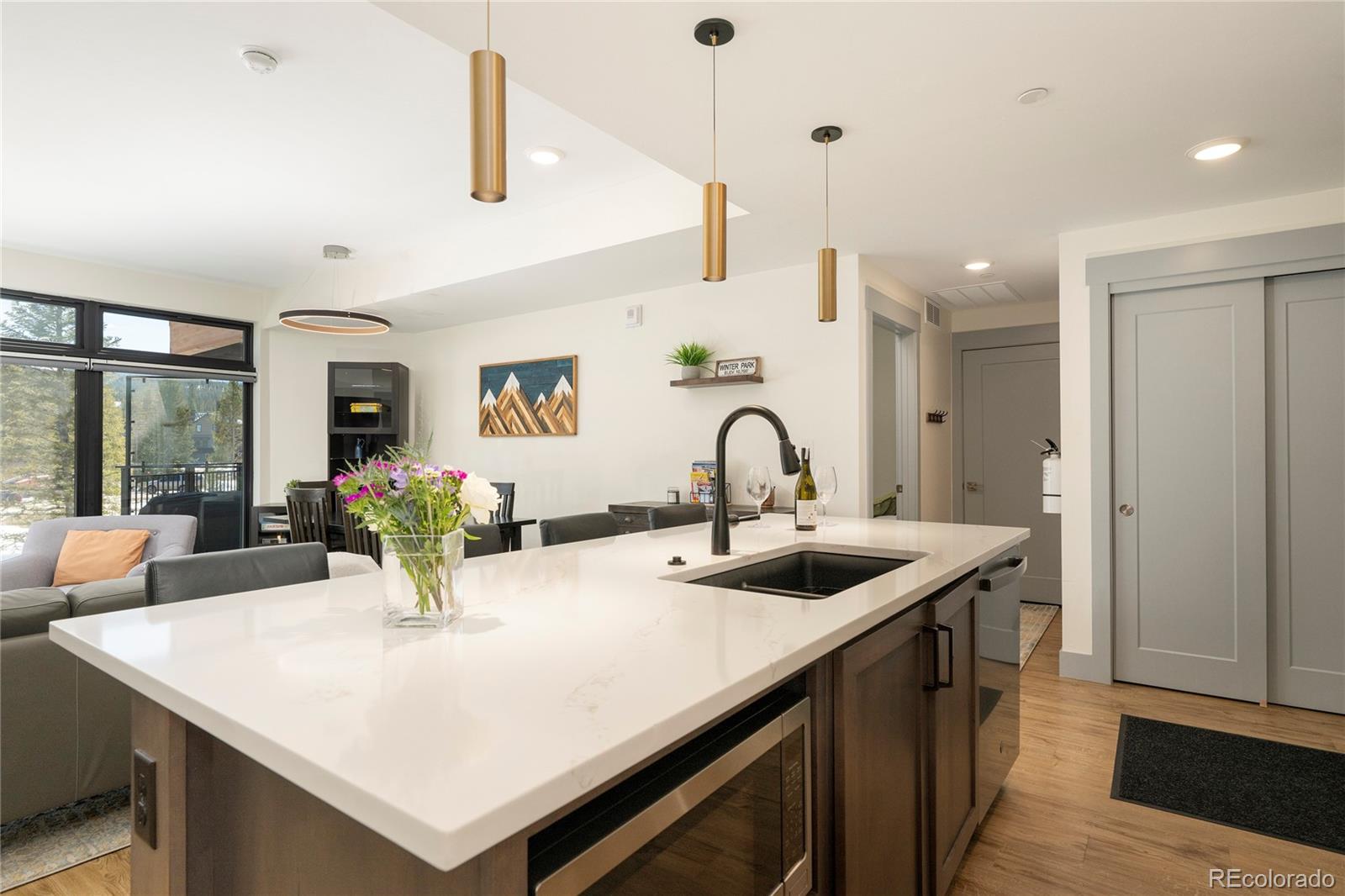 144 Ski Idlewild Road, Unit 2203 Winter Park, CO 80482 - Photo 11 of 45 a kitchen with sink a refrigerator and couches