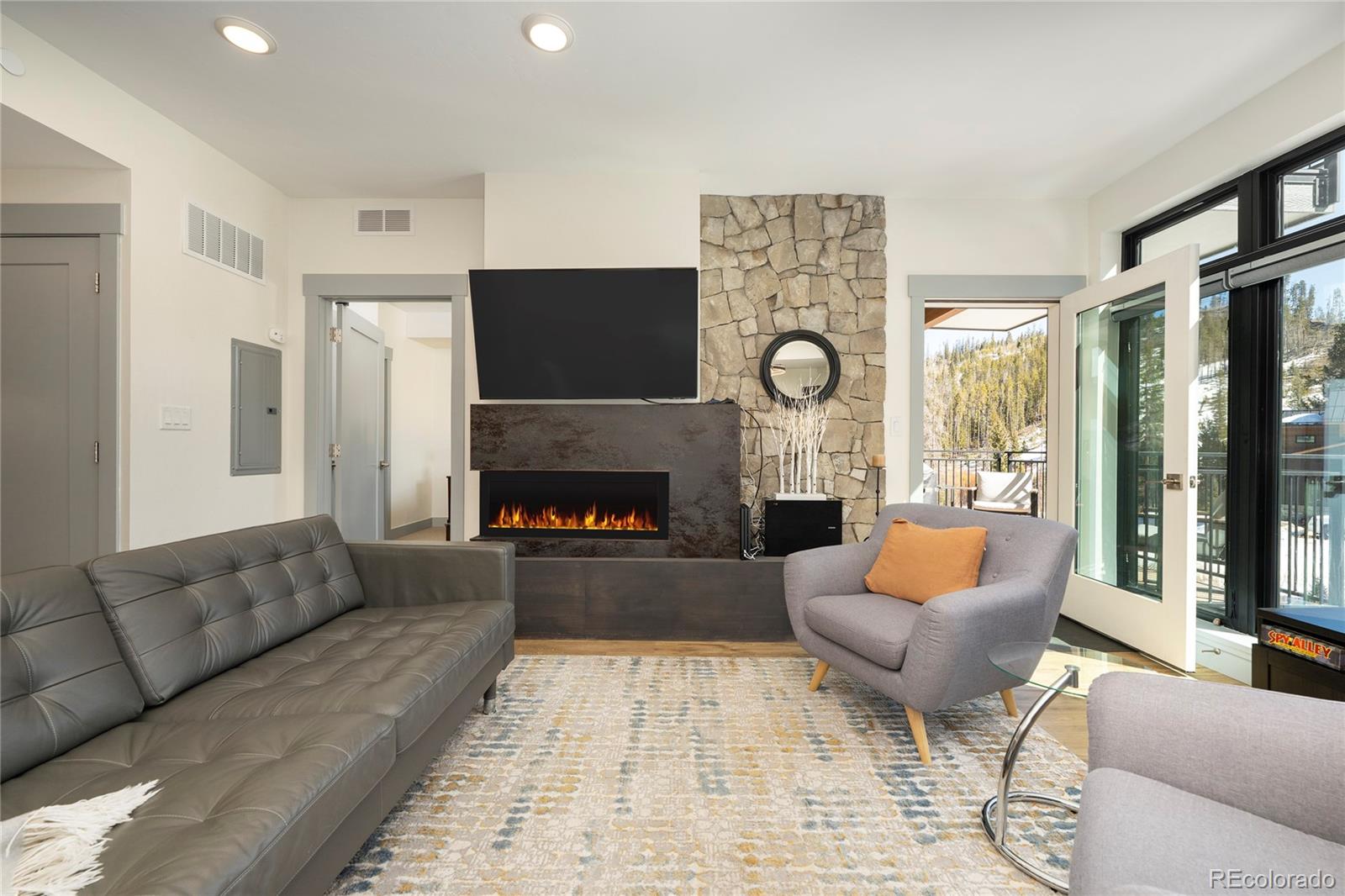 144 Ski Idlewild Road, Unit 2203 Winter Park, CO 80482 - Photo 15 of 45 a living room with furniture and a fireplace