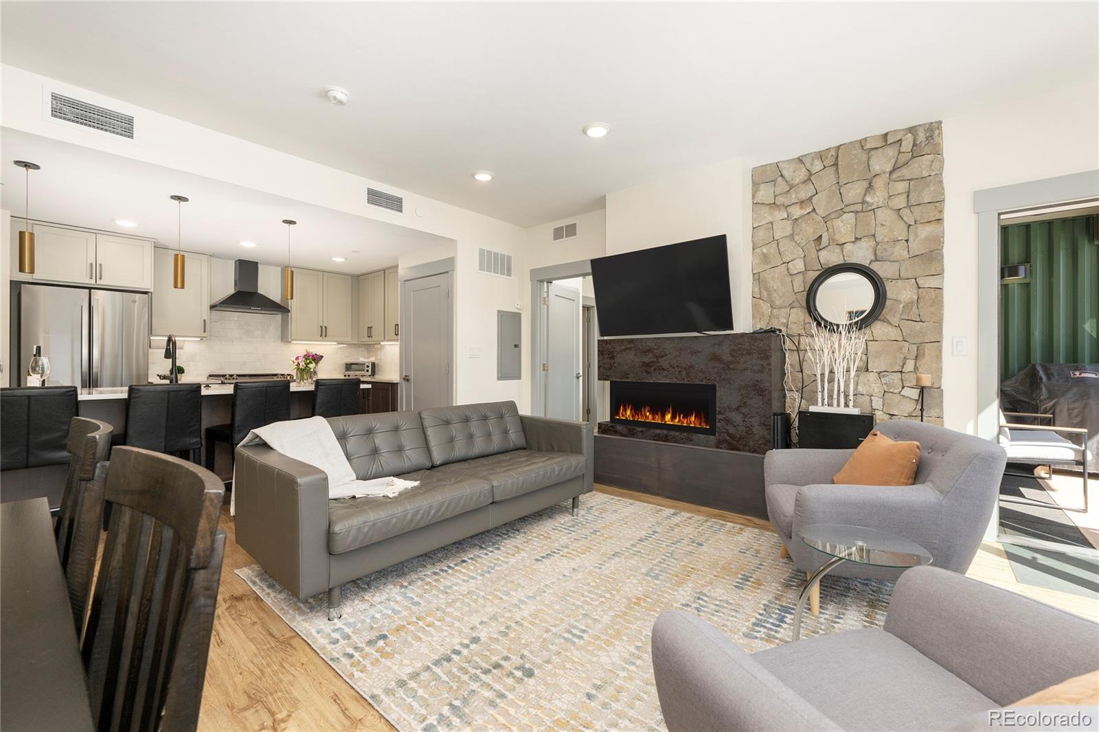 144 Ski Idlewild Road, Unit 2203 Winter Park, CO 80482 - Photo 18 of 45 a living room with furniture a fireplace and a flat screen tv
