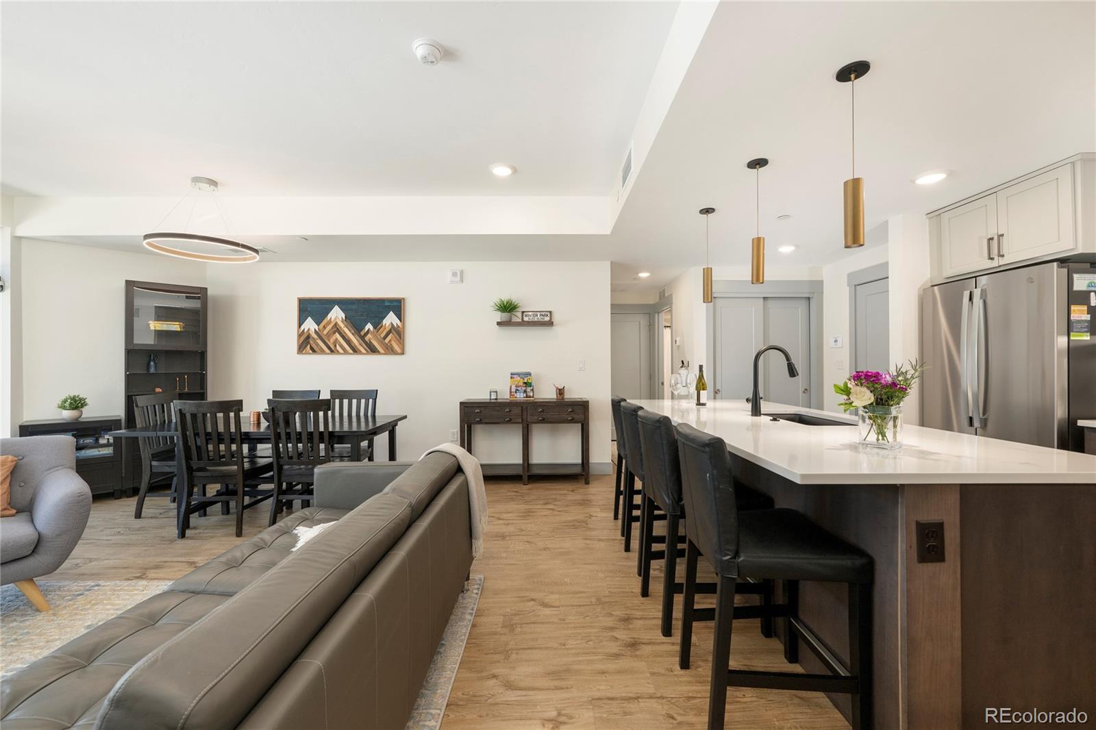 144 Ski Idlewild Road, Unit 2203 Winter Park, CO 80482 - Photo 21 of 45 a living room with stainless steel appliances kitchen island granite countertop furniture and a dining table