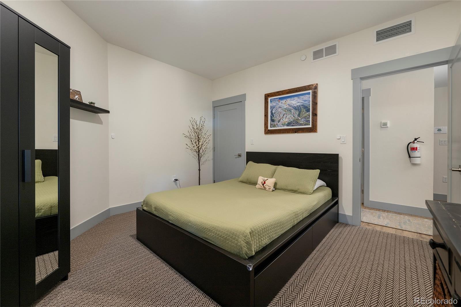 144 Ski Idlewild Road, Unit 2203 Winter Park, CO 80482 - Photo 32 of 45 a large bed sitting in a bedroom and a table