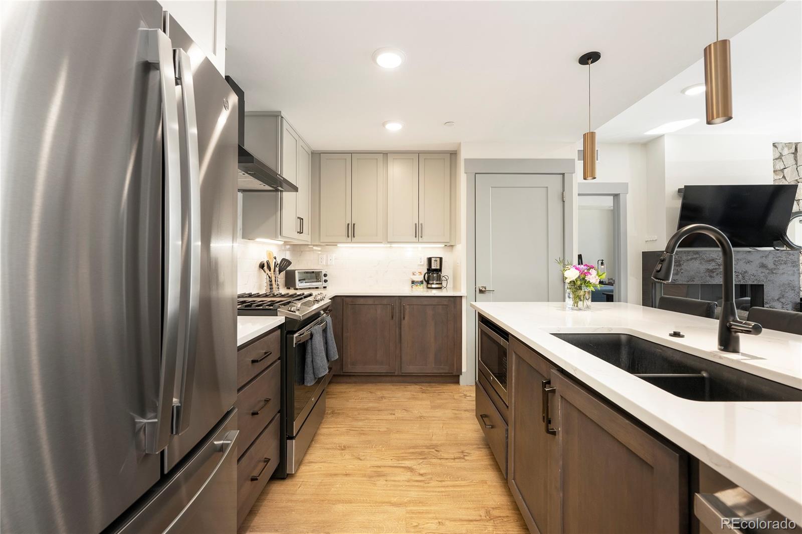 144 Ski Idlewild Road, Unit 2203 Winter Park, CO 80482 - Photo 6 of 45 a kitchen with stainless steel appliances granite countertop a sink stove and refrigerator