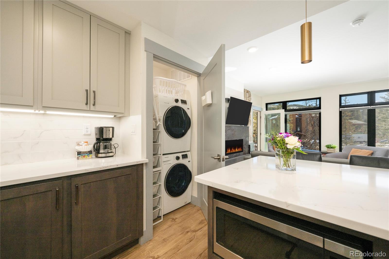 144 Ski Idlewild Road, Unit 2203 Winter Park, CO 80482 - Photo 9 of 45 a kitchen with kitchen island a stove a sink and wooden cabinets