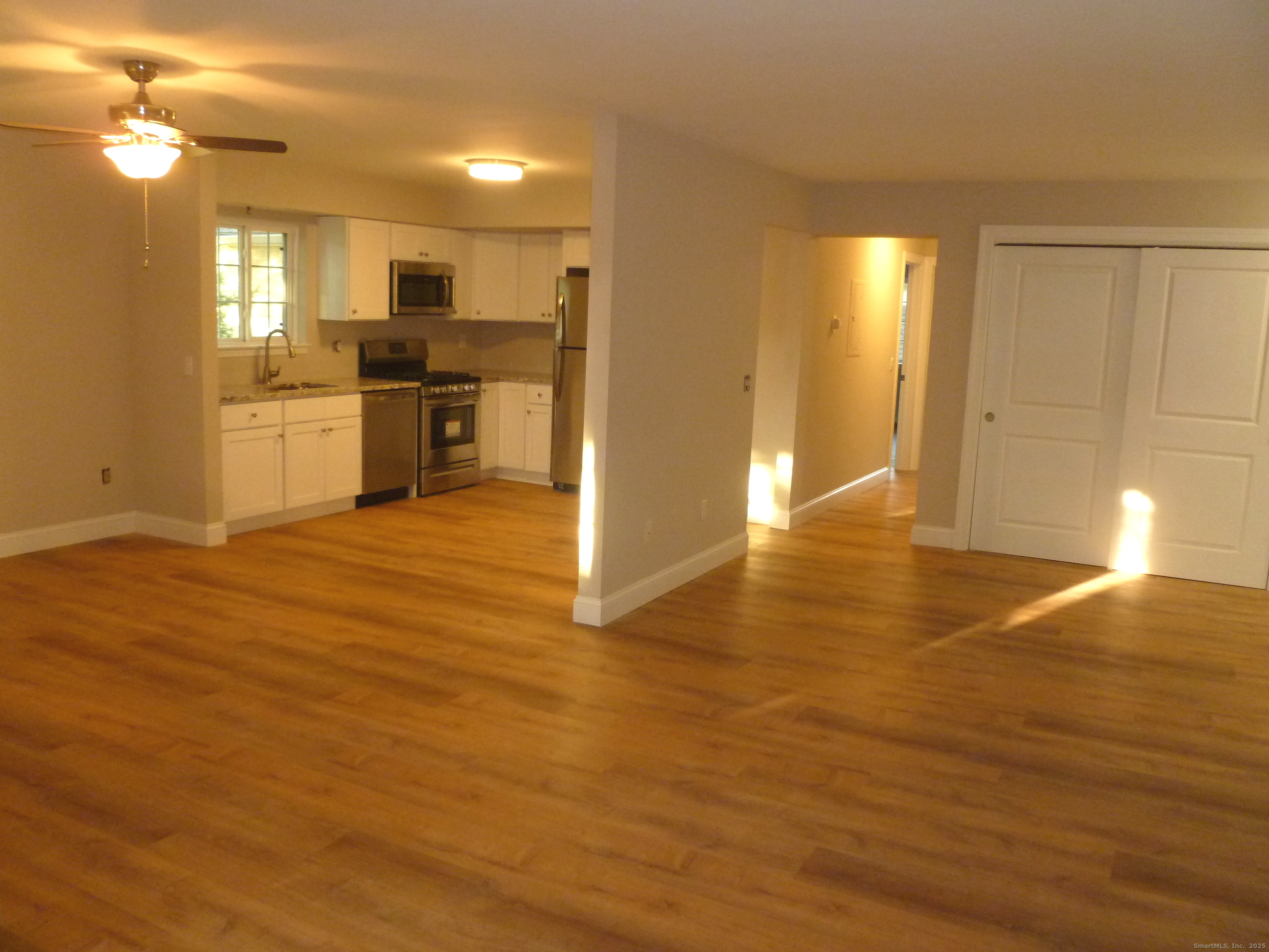 a view of a kitchen with a sink and a refrigerator