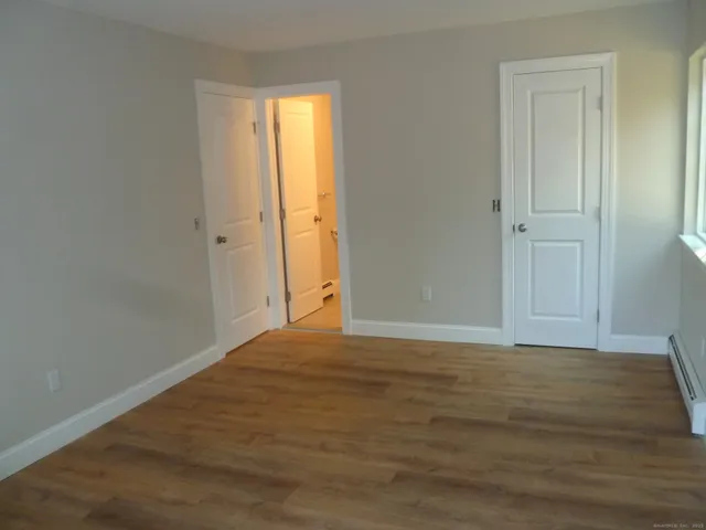 a white toilet sitting next to a bath tub