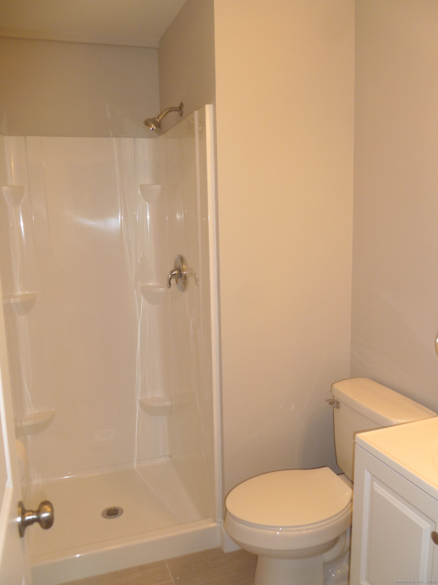 2955 Madison Avenue, Unit 46 Bridgeport, CT 06606 - Photo 25 of 29 a white toilet sitting next to a bath tub