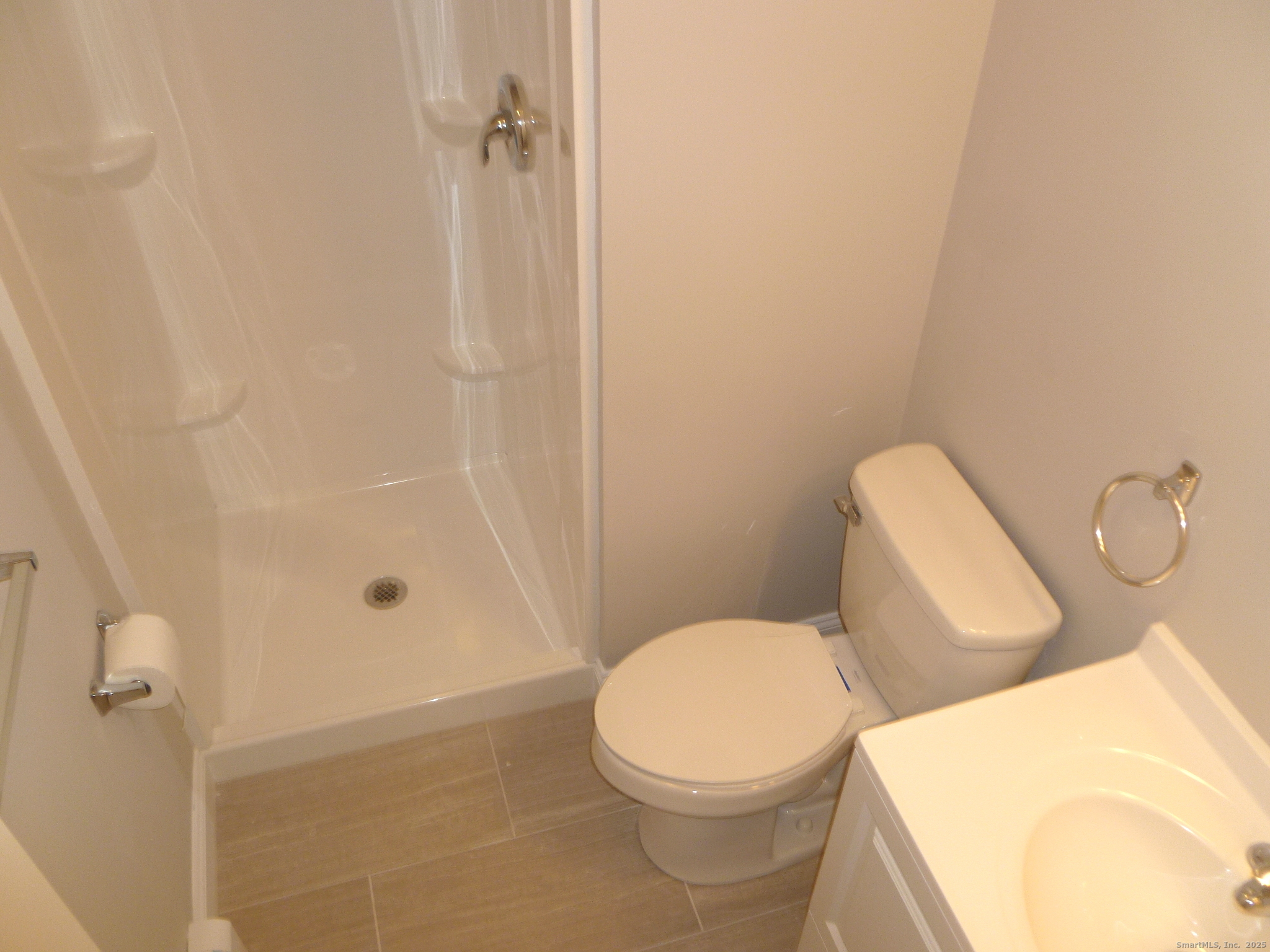 2955 Madison Avenue, Unit 46 Bridgeport, CT 06606 - Photo 26 of 29 a white toilet sitting next to a bathroom sink