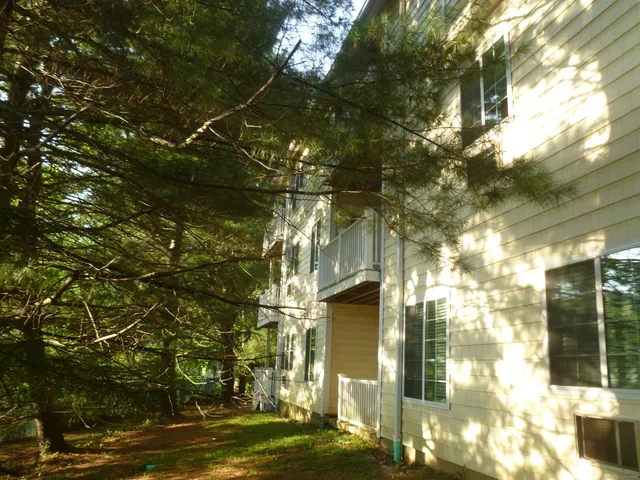 a kitchen with granite countertop a refrigerator stove top oven and sink