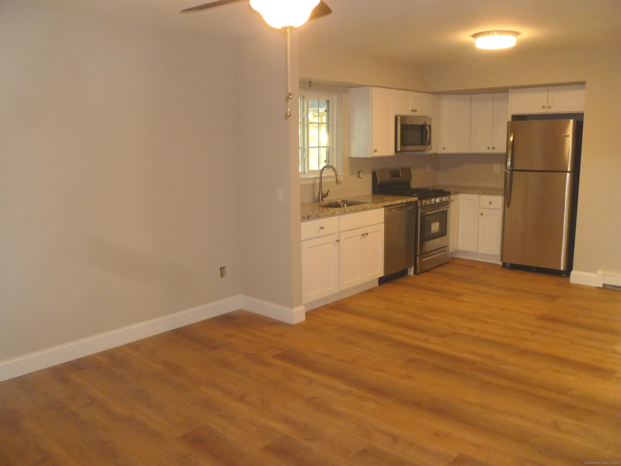2955 Madison Avenue, Unit 46 Bridgeport, CT 06606 - Photo 7 of 29 a kitchen with granite countertop a refrigerator stove top oven and sink