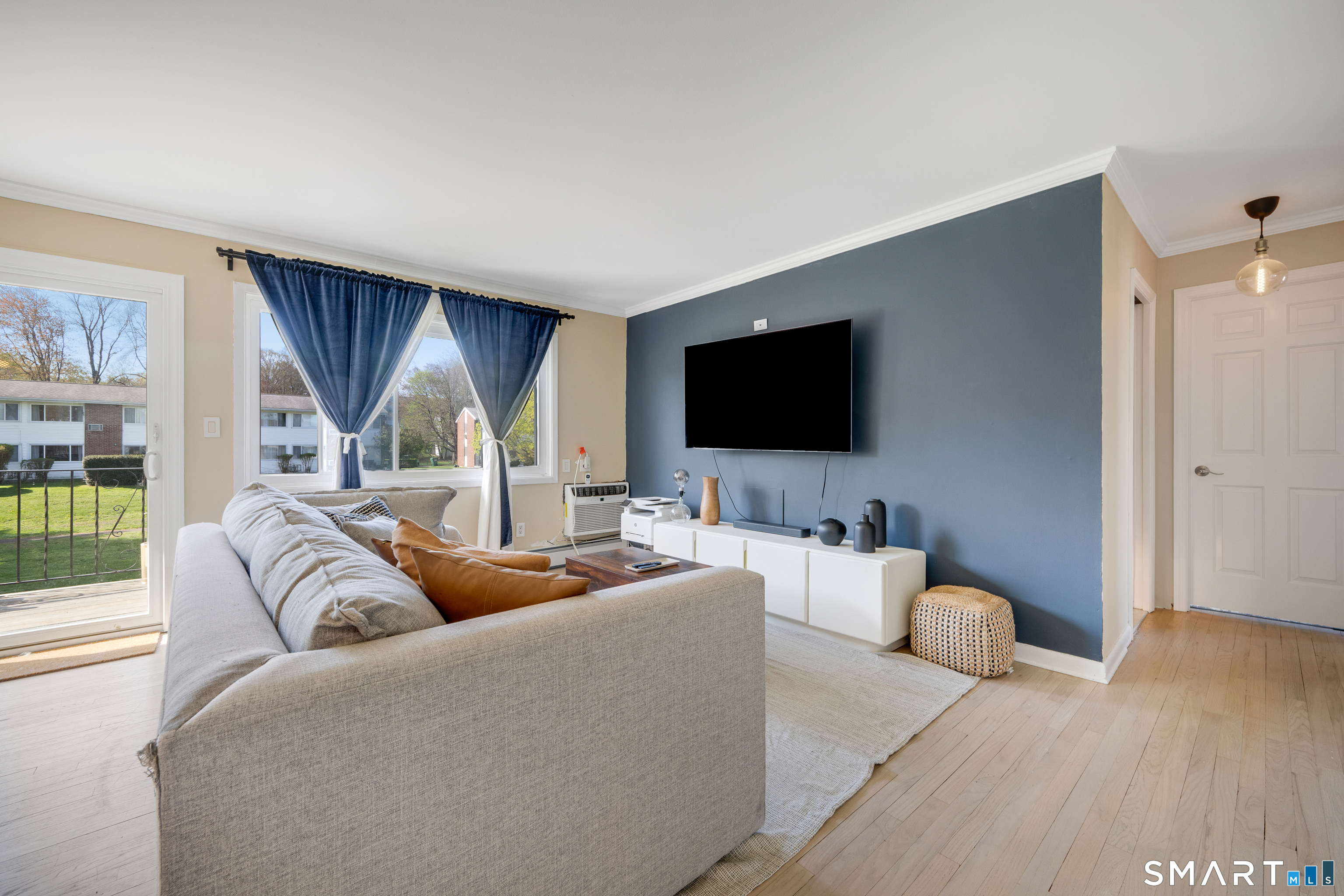 80 County Street, Unit 10F Norwalk, CT 06851 - Photo 13 of 29 a living room with furniture and a flat screen tv