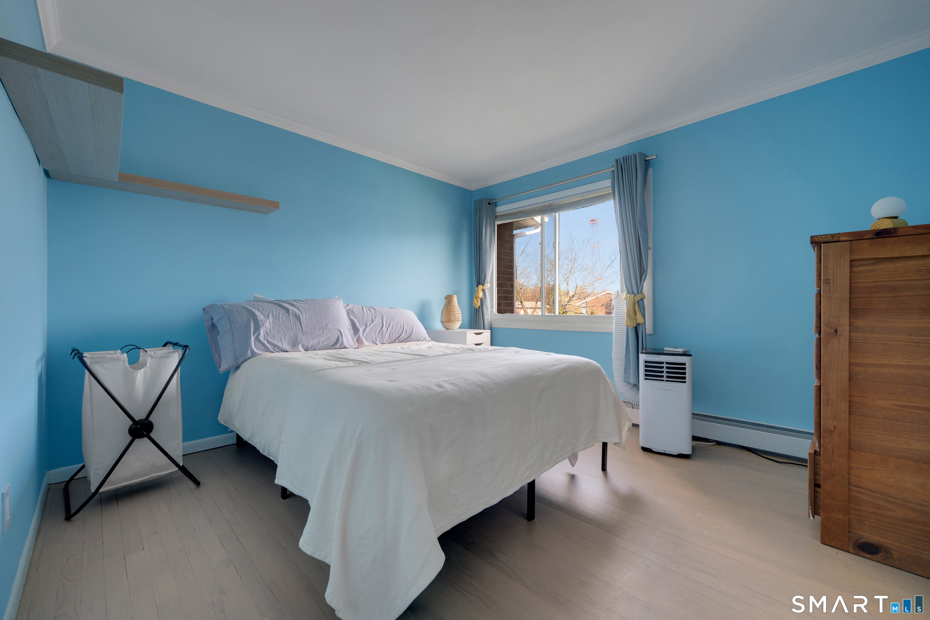 80 County Street, Unit 10F Norwalk, CT 06851 - Photo 19 of 29 a bedroom with a bed and chair