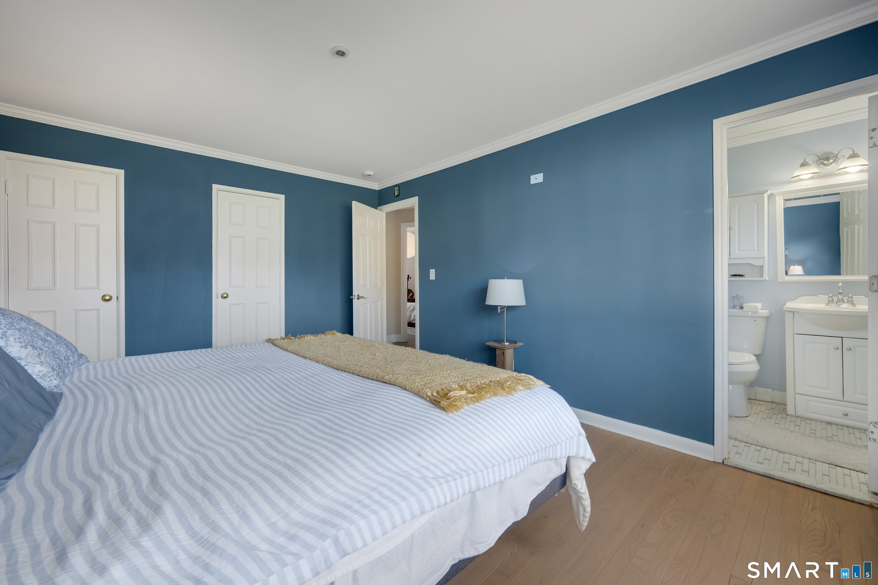 80 County Street, Unit 10F Norwalk, CT 06851 - Photo 21 of 29 a bedroom with a bed and a view of bathroom