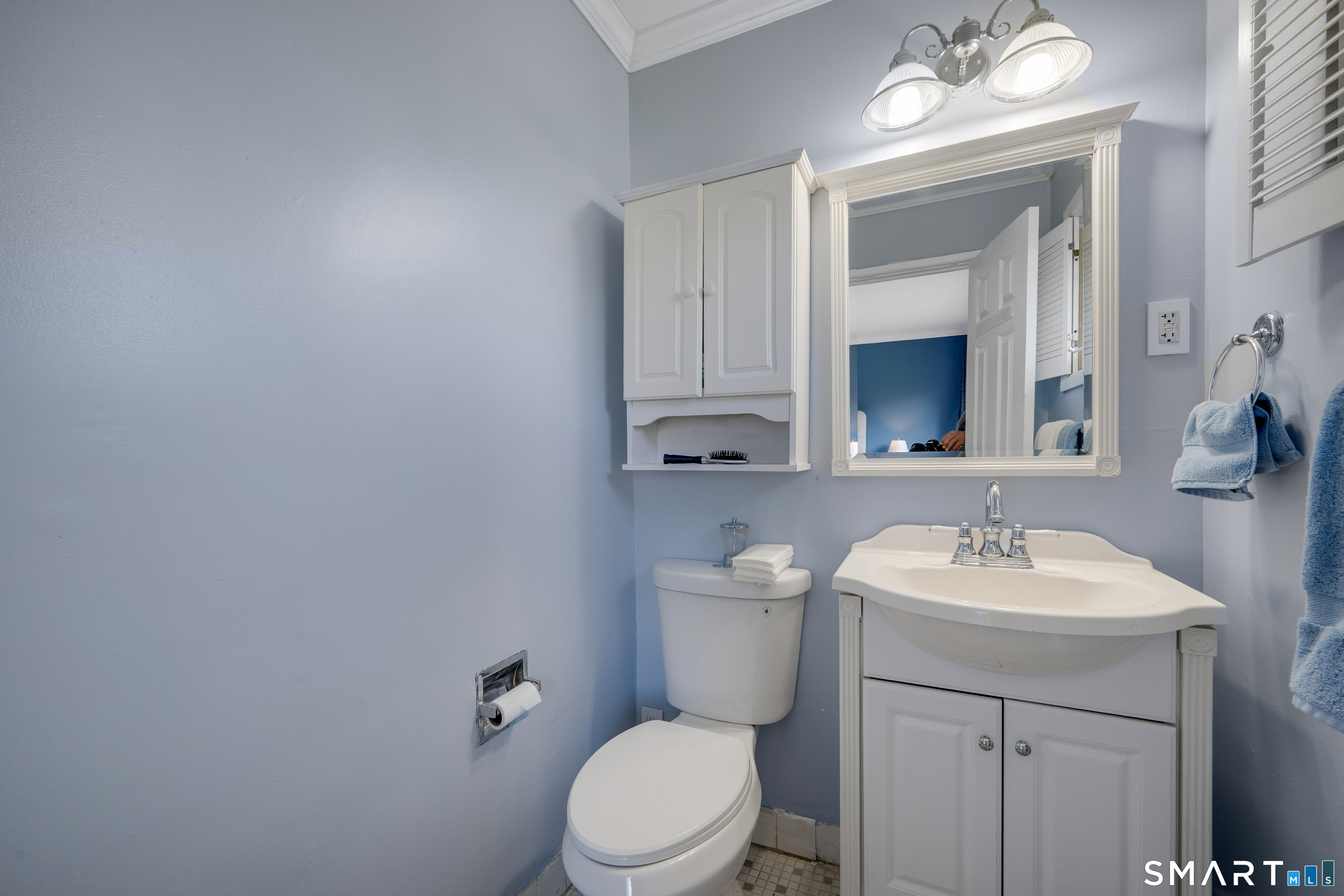 80 County Street, Unit 10F Norwalk, CT 06851 - Photo 22 of 29 a bathroom with a toilet sink and mirror