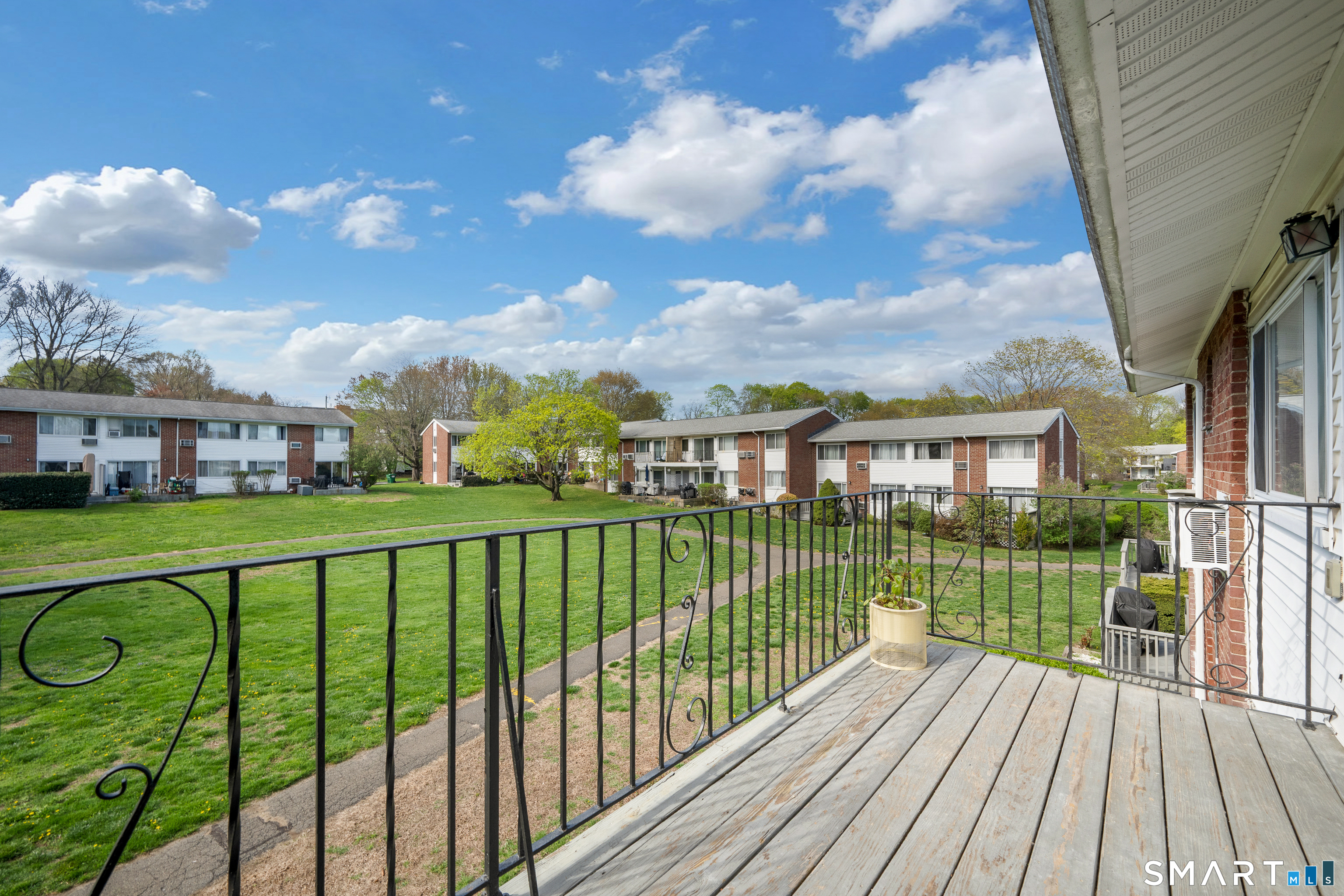80 County Street, Unit 10F Norwalk, CT 06851 - Photo 24 of 29 a view of a wooden deck with a yard