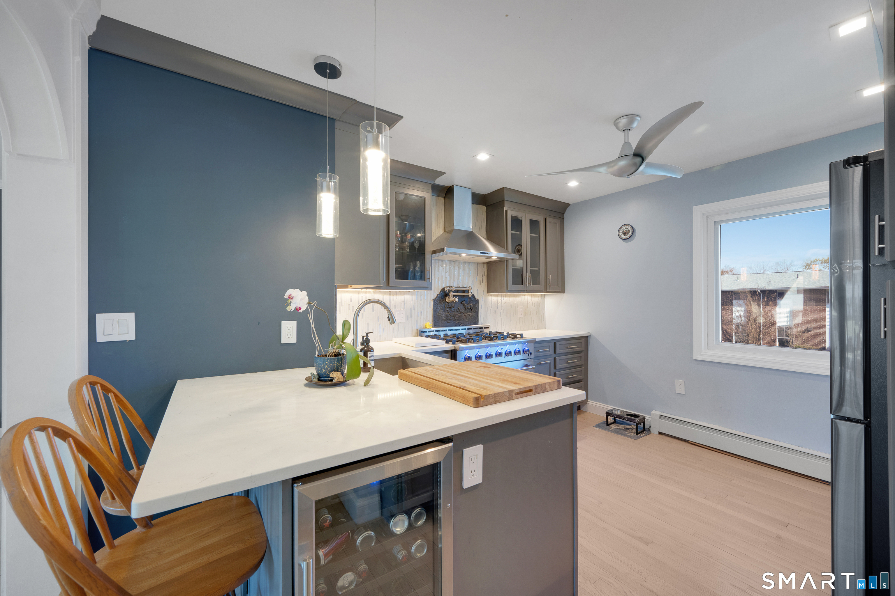 80 County Street, Unit 10F Norwalk, CT 06851 - Photo 8 of 29 a kitchen with a table chairs and a refrigerator