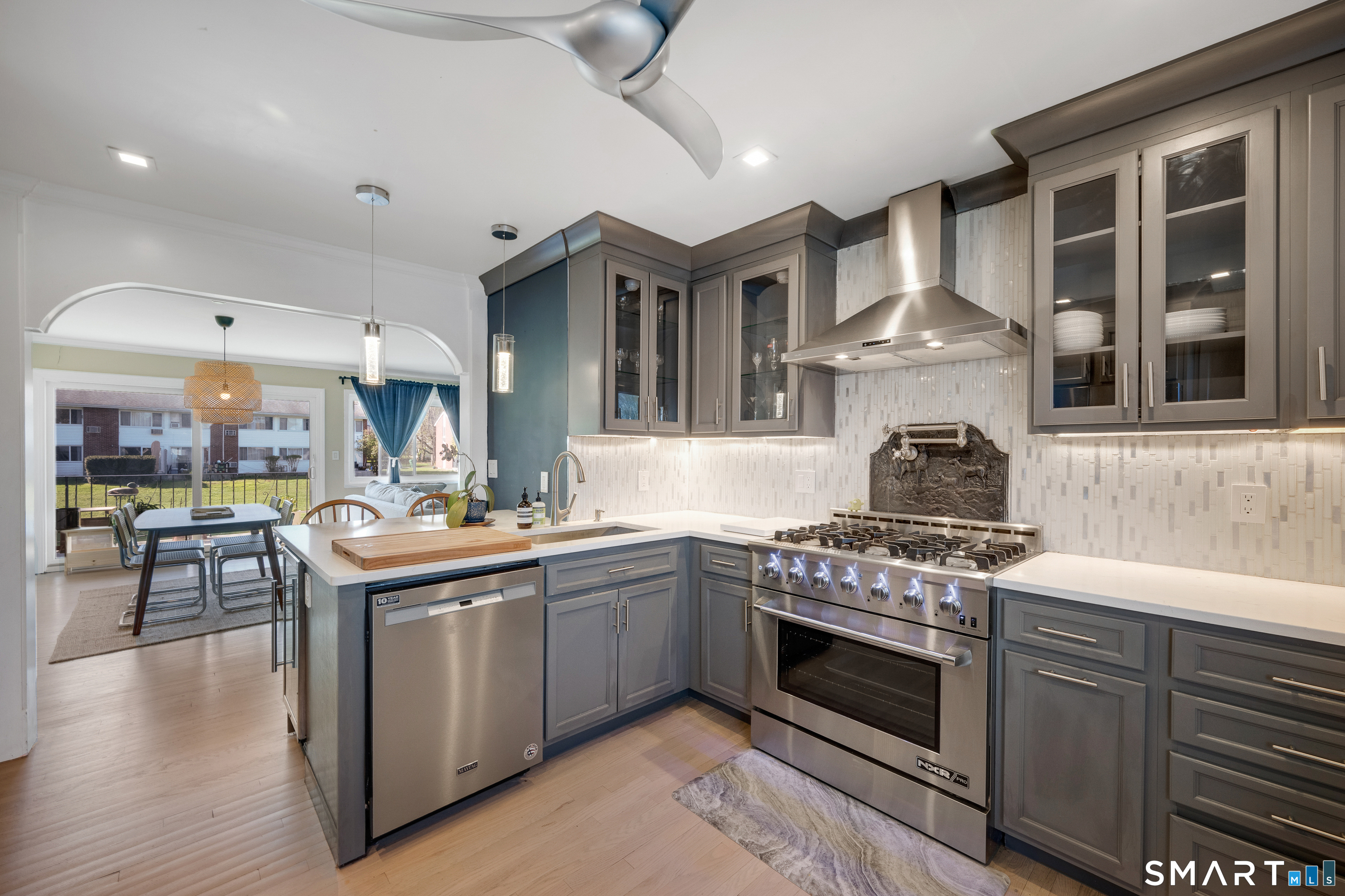 80 County Street, Unit 10F Norwalk, CT 06851 - Photo 9 of 29 a kitchen with stainless steel appliances granite countertop a stove and a sink