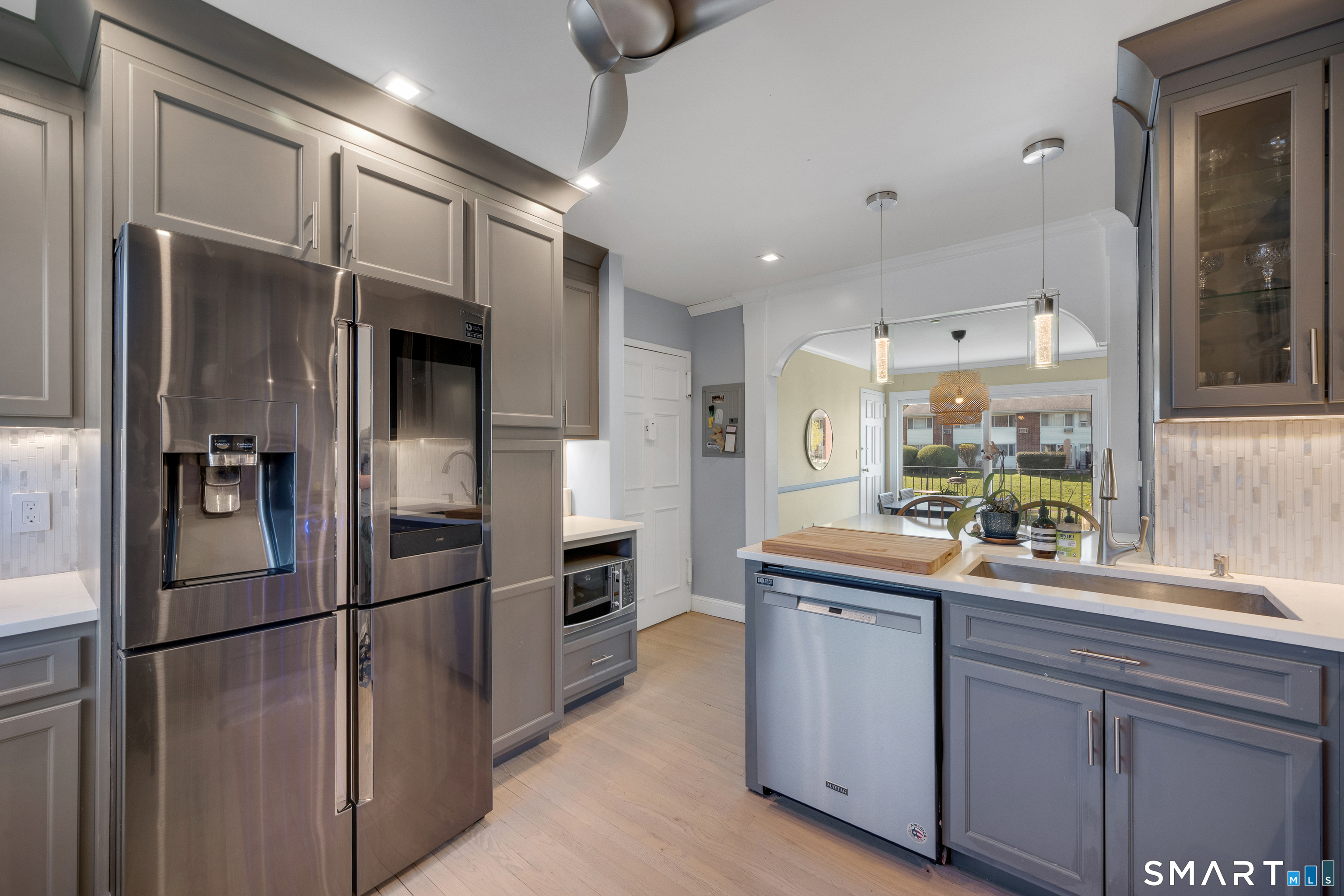80 County Street, Unit 10F Norwalk, CT 06851 - Photo 10 of 29 a kitchen with stainless steel appliances a refrigerator and a sink