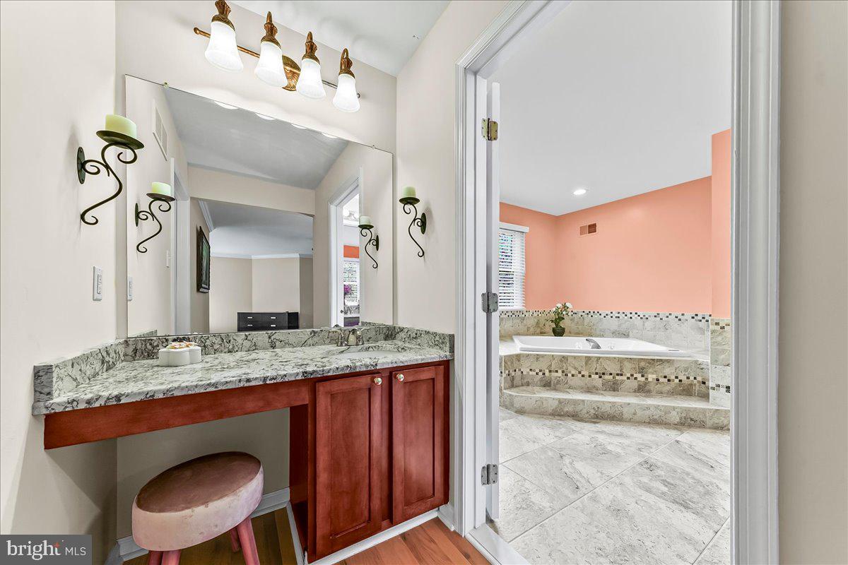 408 Brentford Road Kennett Square, PA 19348 - Photo 23 of 41 a bathroom with a granite countertop sink and a mirror