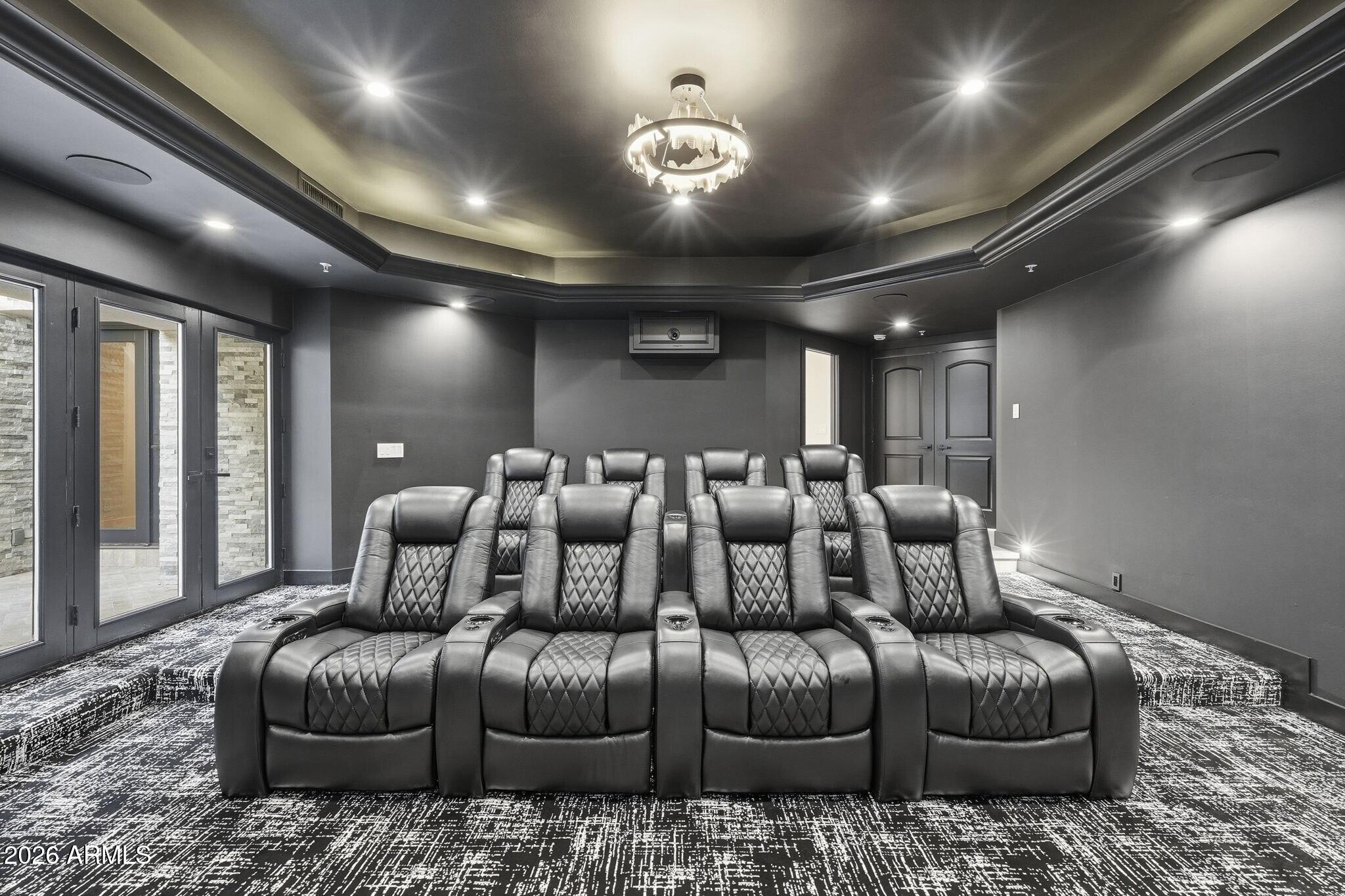 7475 East Gainey Ranch Road, Unit 7 Scottsdale, AZ 85258 - Photo 53 of 77 a media room with lots of chairs and chandelier
