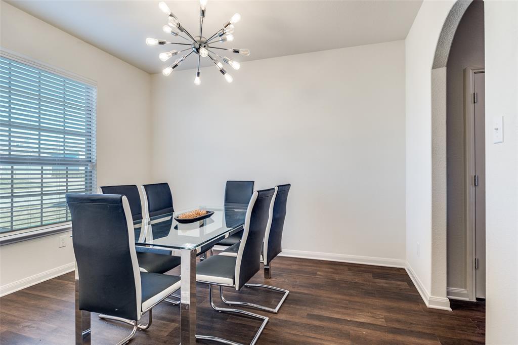 14240 Chaps Drive Dallas, TX 75253 - Photo 11 of 25 a view of a dining room with furniture and wooden floor