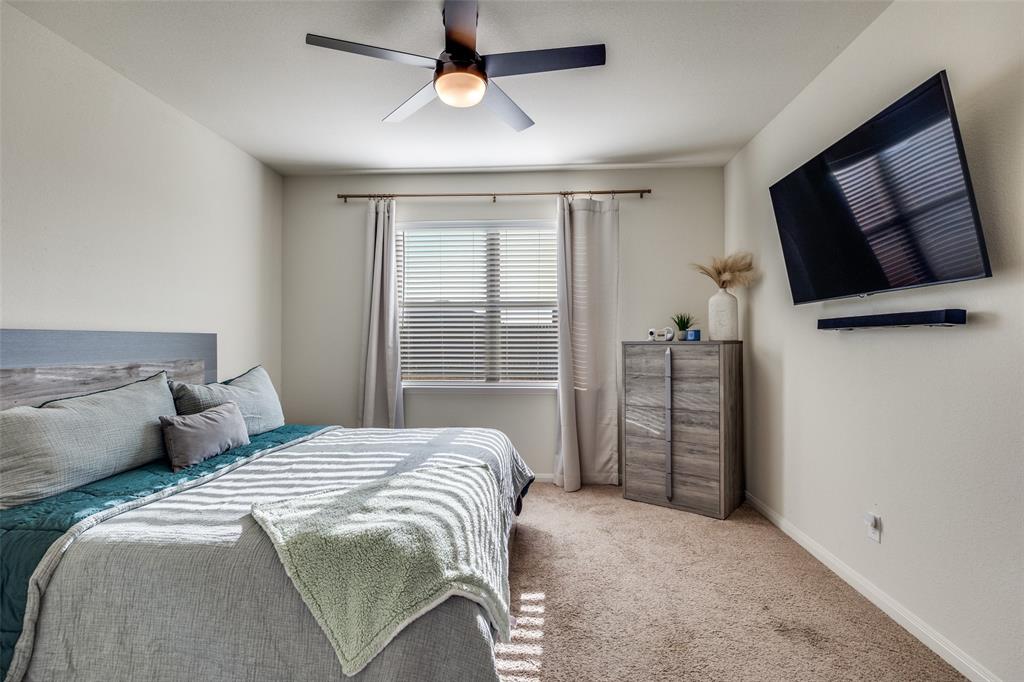 14240 Chaps Drive Dallas, TX 75253 - Photo 14 of 25 a bedroom with a bed tv and a window